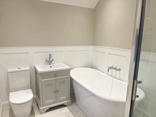 Bathroom panelling with large white bath